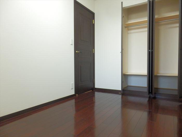 Non-living room. Closet with west Western-style storage door has been divided into two