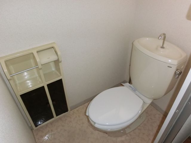 Toilet. It is a toilet with a small window