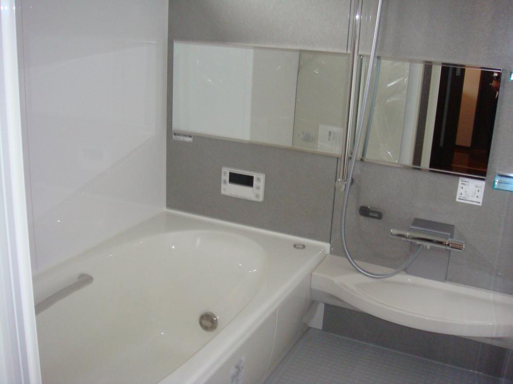 Bathroom. Wide mirror, Standard equipment such as artificial marble bathtub. 