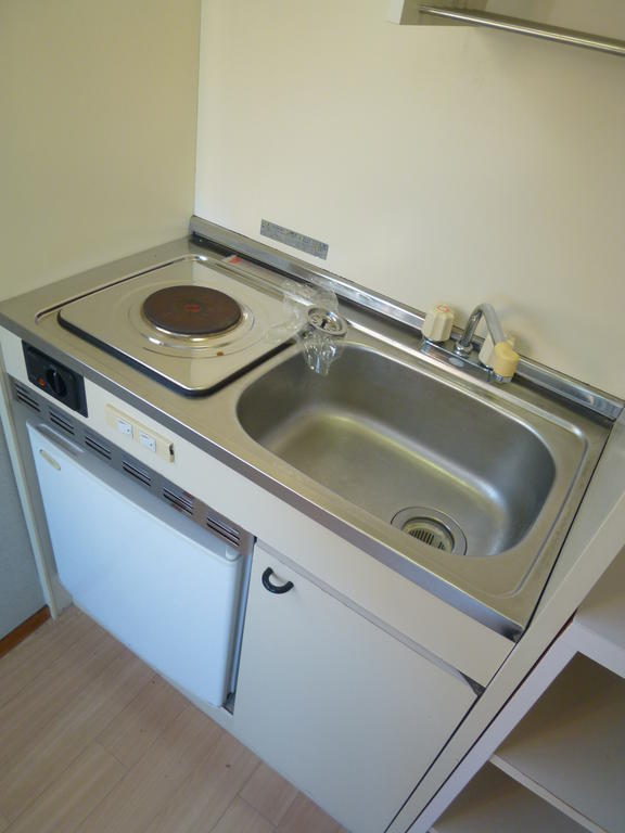 Kitchen. Electric stove With a mini fridge