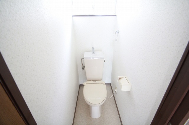 Toilet. It has a small window. 