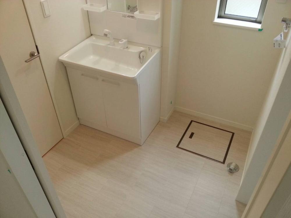 Wash basin, toilet. There is a window in washroom!