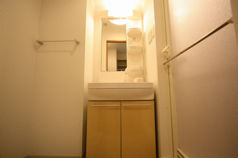 Washroom. Basin is equipped with a large mirror.