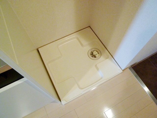 Washroom. Washing machine in the room