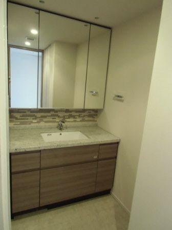 Wash basin, toilet. It has become housed in the back of a large mirror, Tile is also impressive.