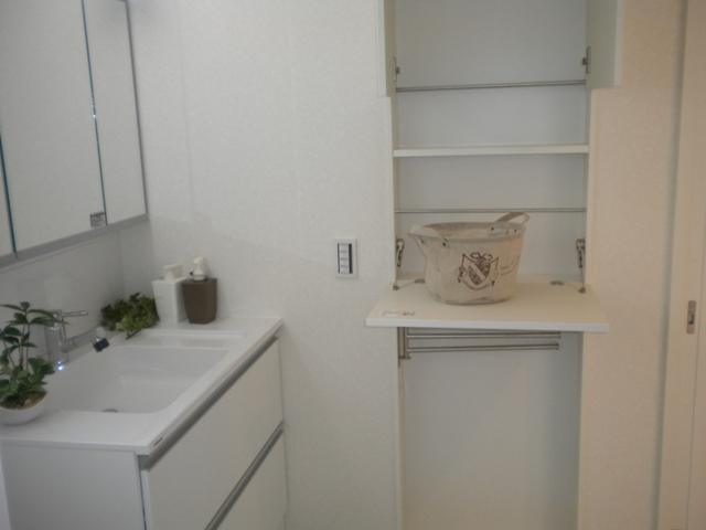 Wash basin, toilet. The washroom is convenient because there is a towel rail and storage. 