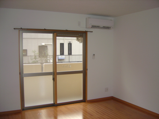 Living and room. South-facing veranda bathed in warm sunshine! The living room is air-conditioned!