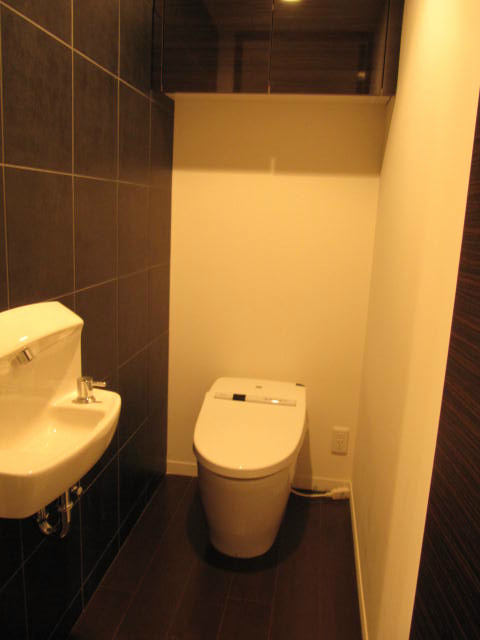 Toilet. With hand-washing sink in the toilet