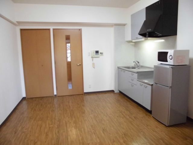 Living and room. There is also a refrigerator and microwave oven