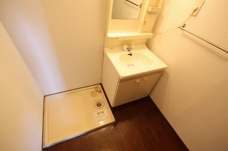 Washroom. Sink and washing machine inside the room