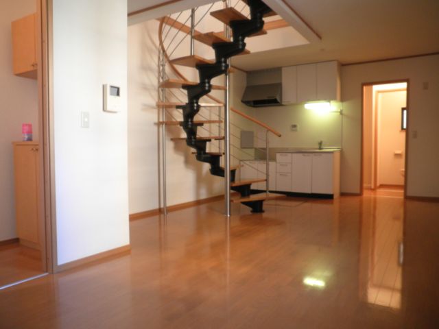 Living and room. It is fashionable there is a spiral staircase in the room. 