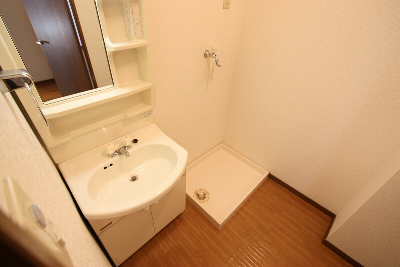 Washroom. Independent sink and washing machine inside the room