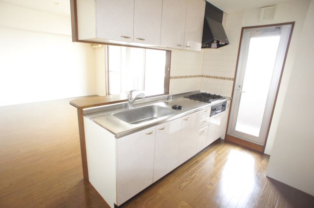 Kitchen. It is counter kitchen living room overlooking pat.