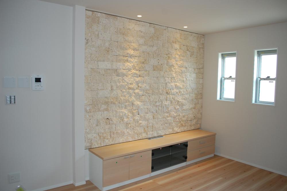 Living. TV station located in the living room. Produce a sense of luxury in paste wall stone. 