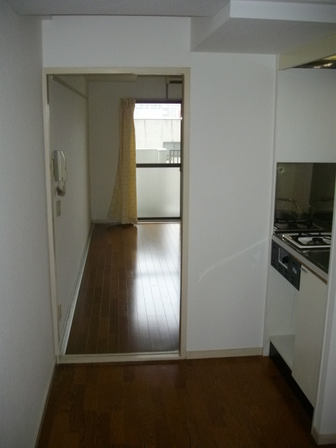 Other room space. It is a photograph of the kitchen part