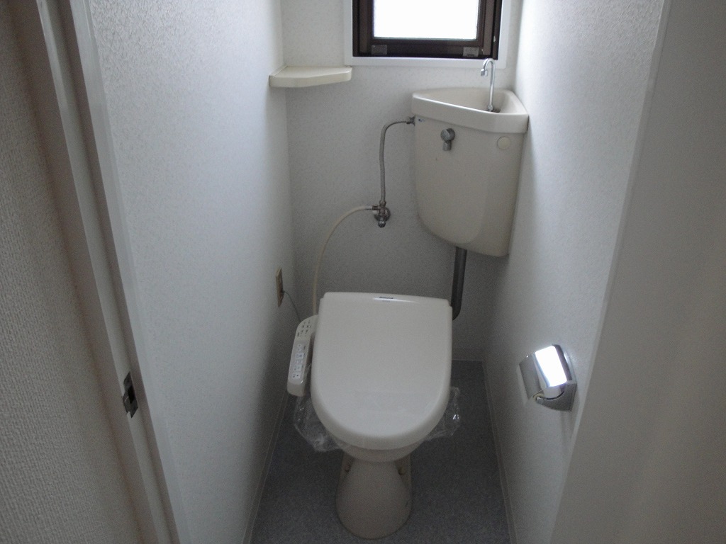 Toilet. Bright toilet there is a window With warm water washing toilet seat