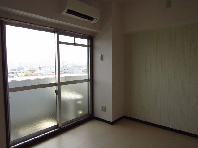 Living and room. It is bright with large windows.