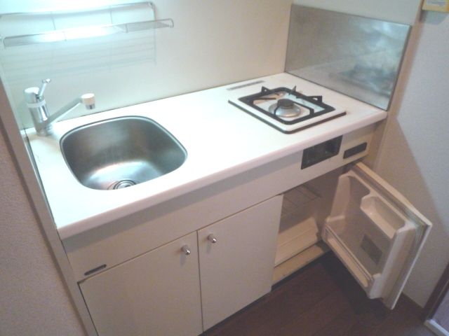 Kitchen. Gas stove With a mini fridge