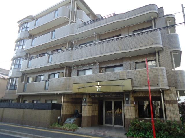 Local appearance photo. Building appearance of sticking brown tile in harmony in the city.