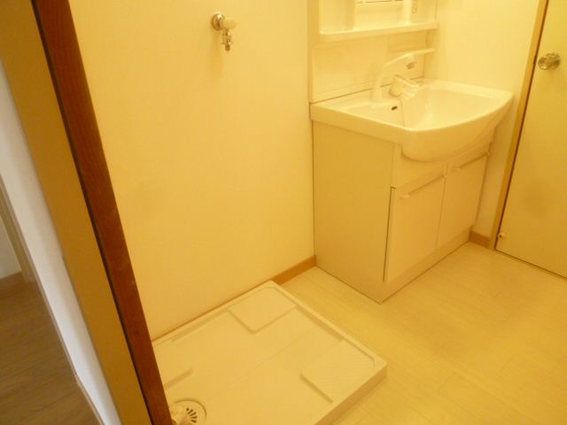 Washroom. It is vanity and a washing machine inside the room. 