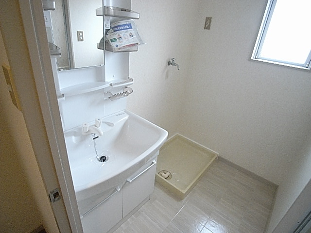 Washroom. Basin is a vanity with shower.