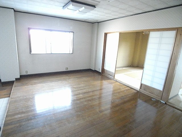 Kitchen. It is bright because there is a window in the middle living