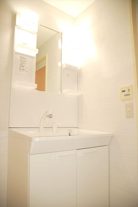 Wash basin, toilet. Vanity white was the keynote