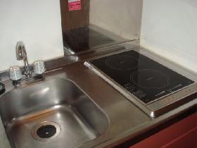 Kitchen. The kitchen is equipped with storage shelves in under the sink. 