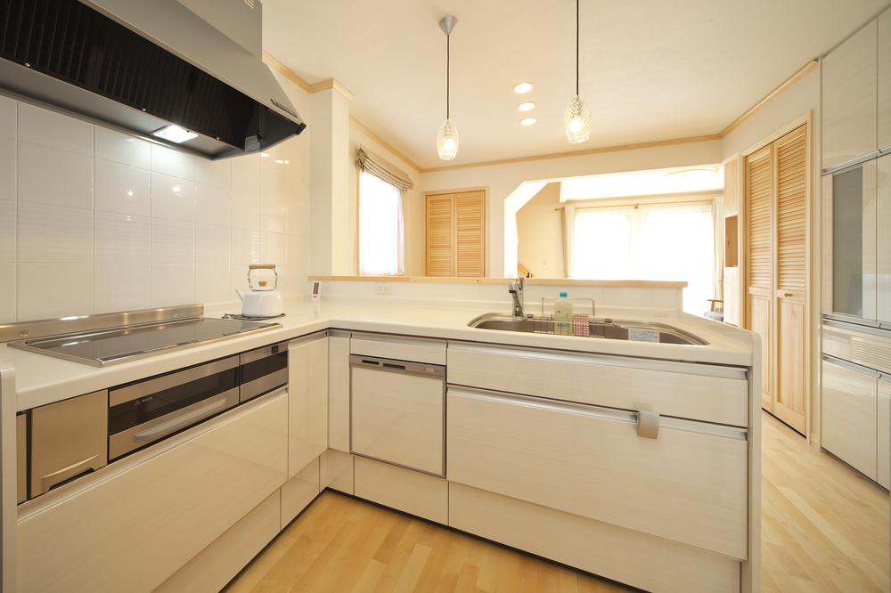 Kitchen. The bright white kitchen equipped also back storage. 