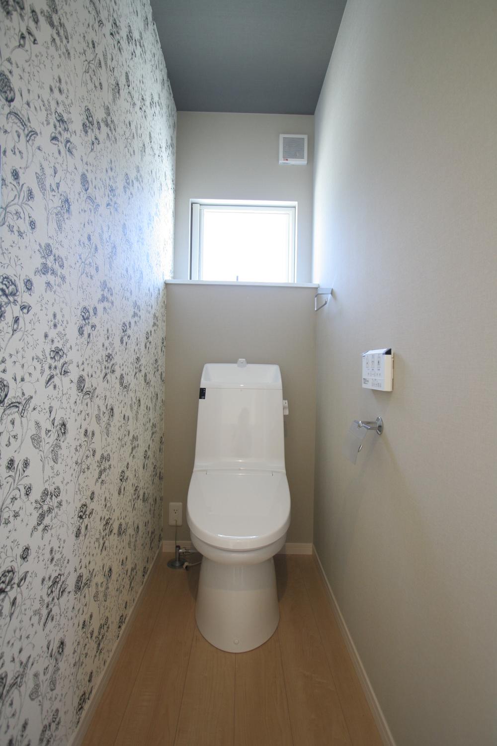 Toilet. Toilet stuck to the wallpaper. 