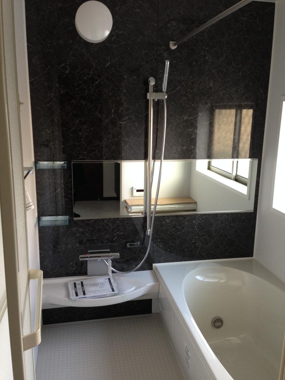 Bathroom. A large mirror and a large tub. 