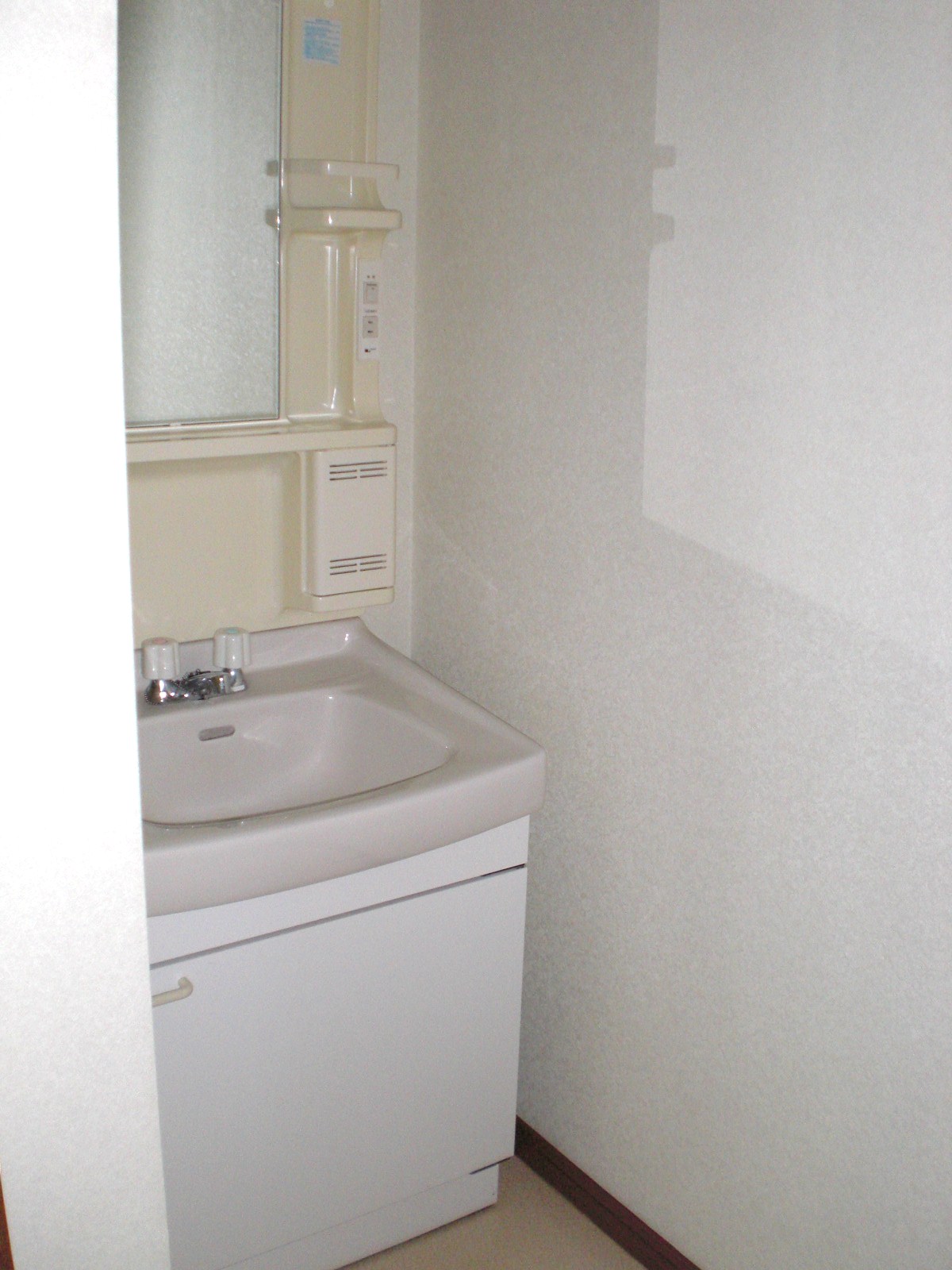 Washroom. There is a washing machine storage independently washbasin opposite