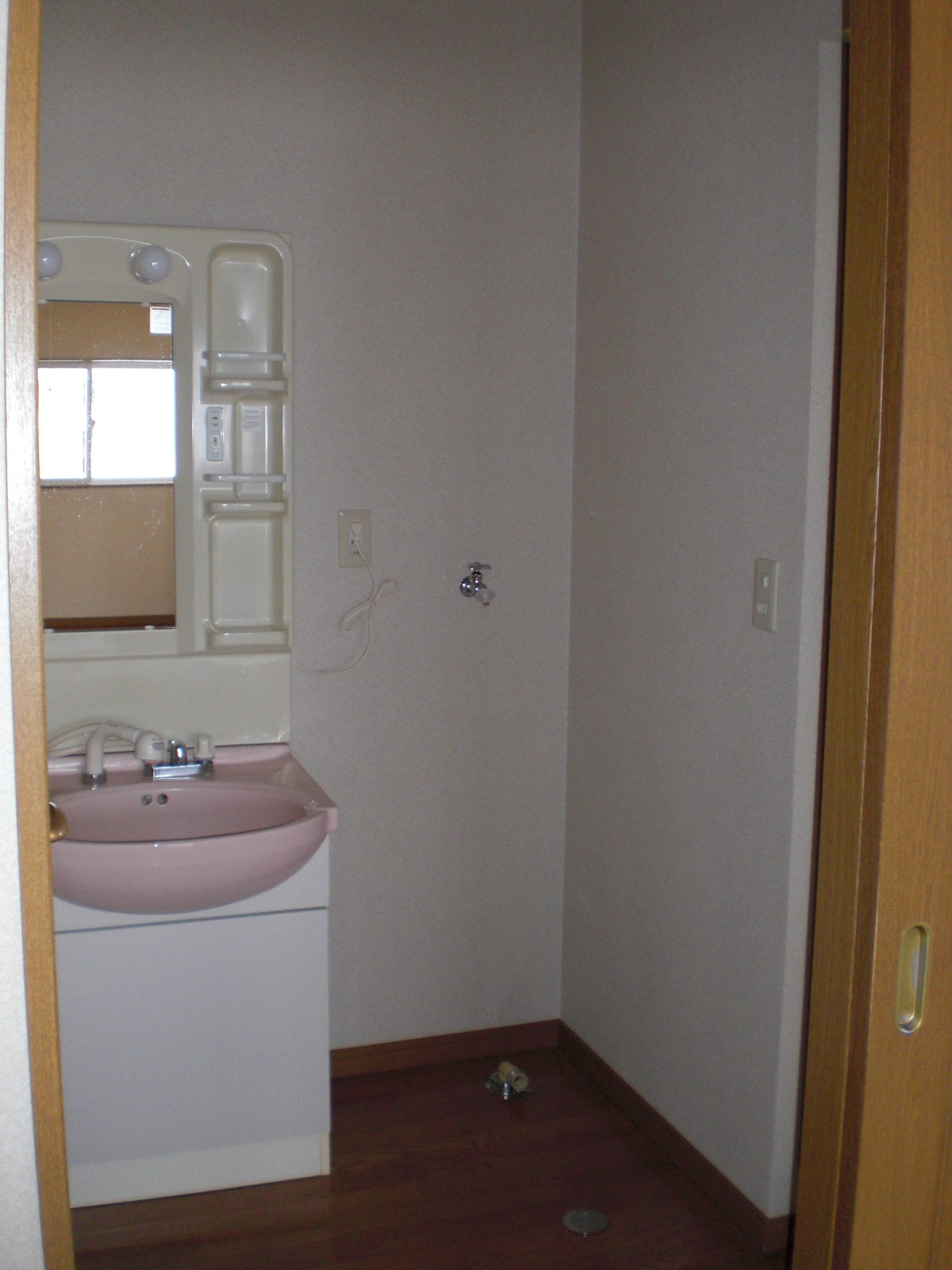 Washroom. The washroom has a wash basin with washing machine storage and shower