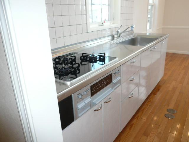 Kitchen. Glass top stove of new. It is a white kitchen with cleanliness. 