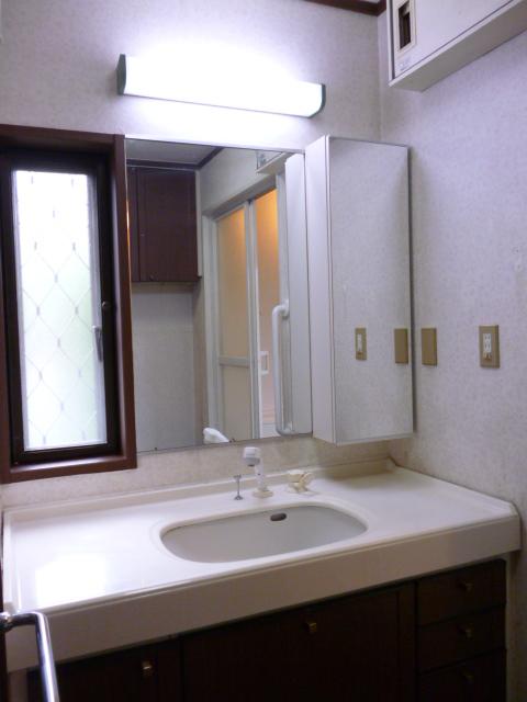 Wash basin, toilet. Basin space and spacious.