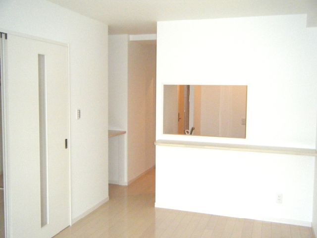 Living and room. It is a photograph of the other room.