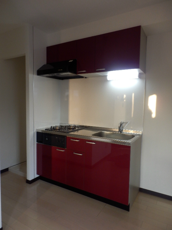 Kitchen. It is cute bright red kitchen