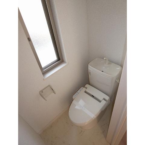 Toilet. There is a small window