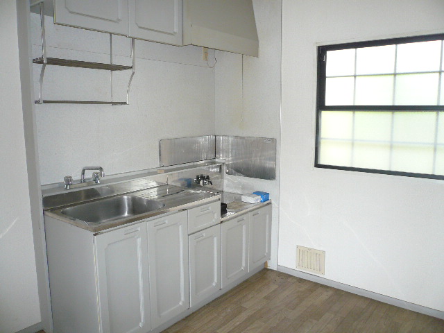 Kitchen. It is a bright kitchen with a large window.