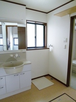 Washroom. There is a small window is bright wash room. There is a washing machine storage.