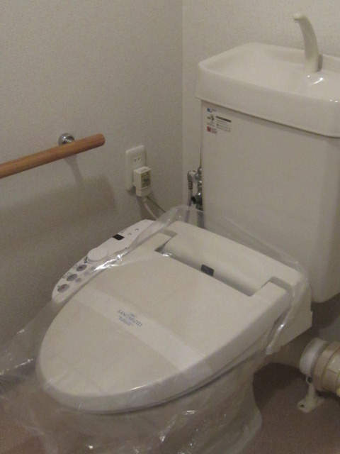 Toilet. Handrail income Cleaning function with toilet seat