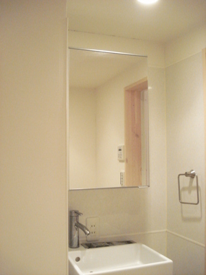 Washroom. Wash basin with vanity that white was the keynote