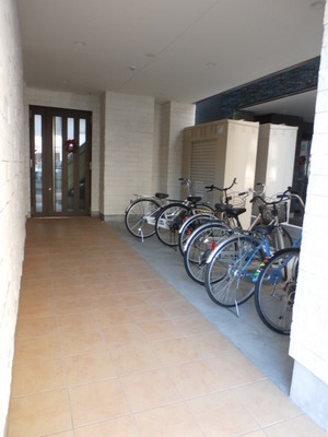 Parking lot. Entrance (with roof) is a bicycle parking.