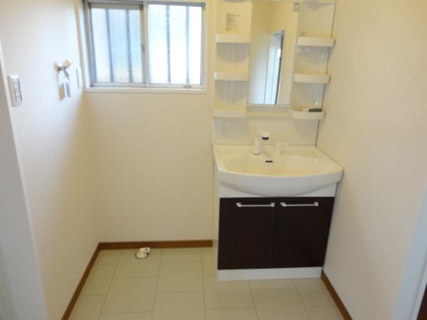 Wash basin, toilet. Bathroom vanity, Now washroom with a clean and place stick Cross