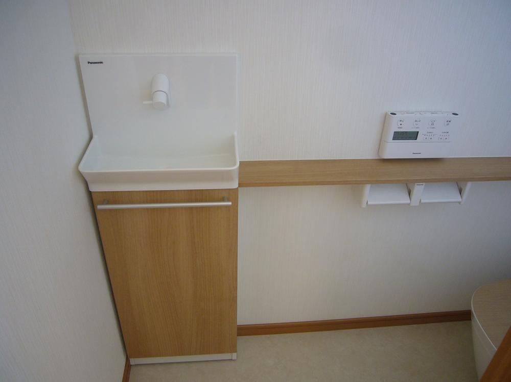 Toilet. Hand wash stand in the toilet