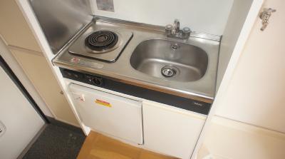 Kitchen. This bite stove and a mini fridge marked with system kitchen.