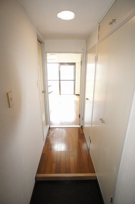 Entrance. The right front is housed, The back washing machine storage. Left is the unit bus. 