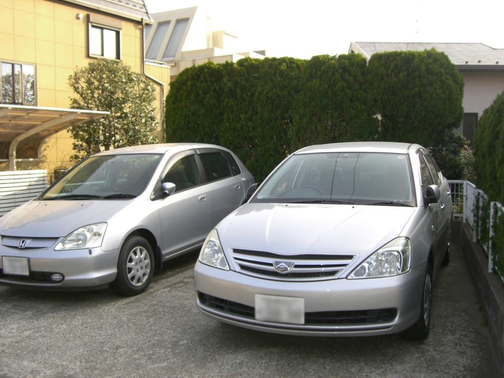 Parking lot. Parking space There are three cars