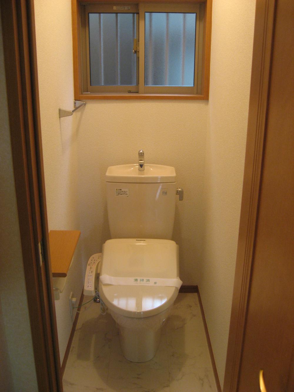 Toilet. Remote control integrated toilet. Also it comes with a towel hanger.