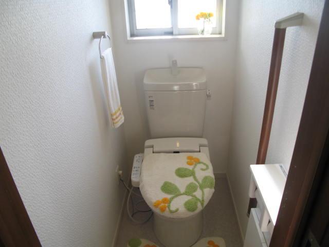 Toilet. Handrail is attached. Clean with a paper with storage!